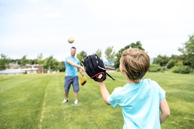 Dad and son playing catch with a baseball